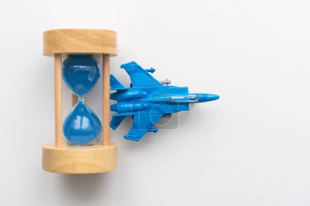 Expected time of arrival, flight delay and arrival concept. plane on hourglass with copy space for text. High quality photo
