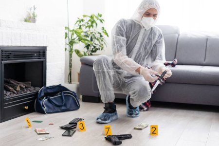 Detective Collecting Evidence in a Crime Scene. Forensic Specialists Making Expertise at Home of a Dead Person. Homicide Investigation by Professional Police Officer. High quality photo