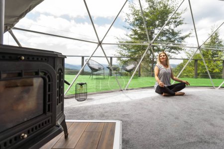 woman doing yoga Glamping house . Healthy lifestyle concept. Weekend getaway at glamping. mental healing.