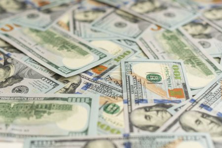 Sehr große Mengen an US-Hundert-Dollar-Scheinen schließen sich an. Riesige Menge an US-Banknoten auf flachem Tisch. Hochwertiges Foto