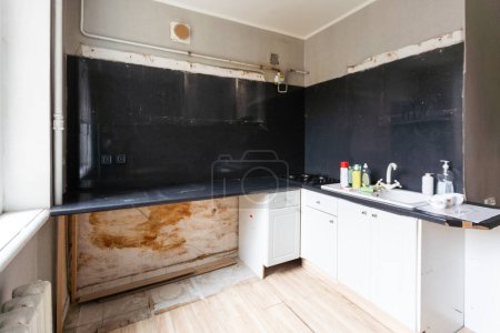 an old style kitchen room with white tiled walls. High quality photo