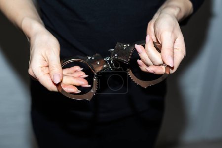 steel handcuffs of police special equipment, fetters on a black background. High quality photo