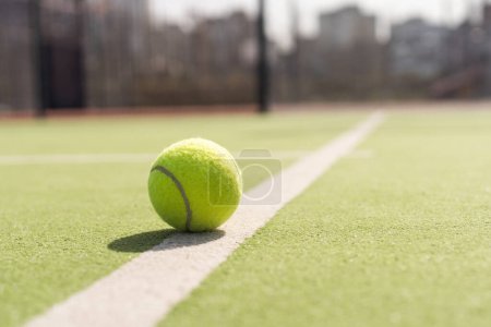Tennis ball on a tennis court next to the side line. High quality photo