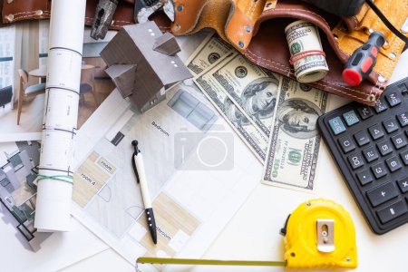 Working on construction project background. Office table with dollars and pen. High quality photo