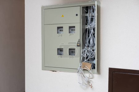 Photo for Electric cabinet with Internet and television cables in an apartment building. Niche for wires and cables inside the wall. - Royalty Free Image