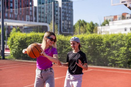 Téléchargez les photos : Mère et fille jouent au basket. Haute qualité - en image libre de droit