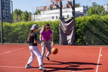Photo for Concept of sports, hobbies and healthy lifestyle. Young people playing basketball on playground outdoors. High quality photo - Royalty Free Image