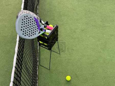 Background of padel racket and ball on artificial grass floor in outdoor court. Top view. High quality photo