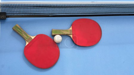 Table tennis rackets and ball on tennis table. High quality photo