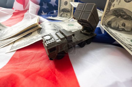 War, military threat, military power concept. USA. military vehicle toy near american flag . High quality photo