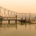 Kolkata, India, January 24, 2023: Howrah Ferry Ghat overlooking Famous Howrah Bridge at the time of Sunset.