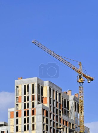 Photo for Building crane and construction against blue sky - Royalty Free Image