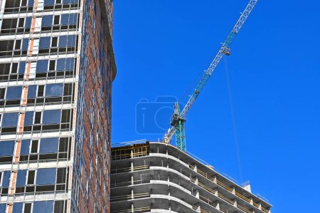 Photo for Tower crane and construction against blue sky - Royalty Free Image