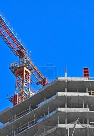 Photo for Highrise construction site with crane and blue sky - Royalty Free Image