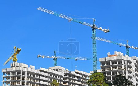 Photo for Multistory construction site with crane and blue sky - Royalty Free Image
