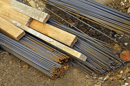 Armature rod for reinforcing and wooden beam on construction site