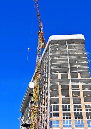 Photo for Multistory construction site with crane and blue sky - Royalty Free Image