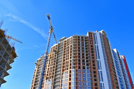 Highrise construction site and crane with blue sky