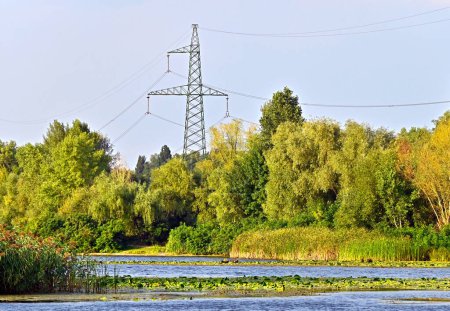 Suburban high voltage transmission line over river in Ukraine