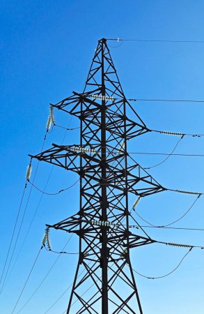 High voltage transmission line over blue sky background