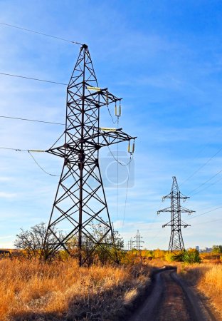 High voltage transmission line over blue sky background