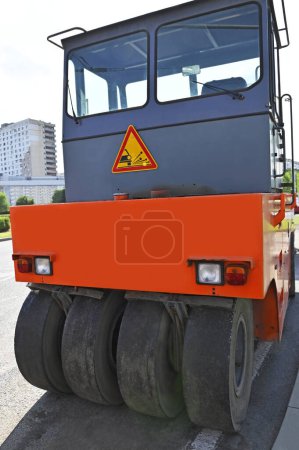 Photo for Pneumatic road roller machine on urban roadwork site - Royalty Free Image
