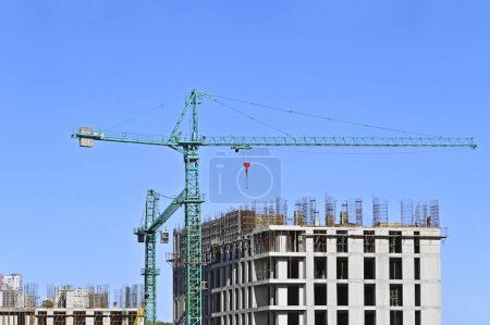Photo for Crane and building construction site against blue sky - Royalty Free Image