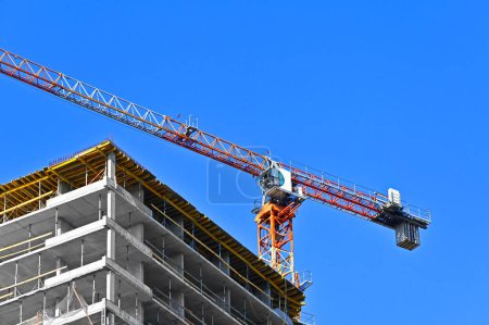 Photo for Crane and construction site against blue sky - Royalty Free Image