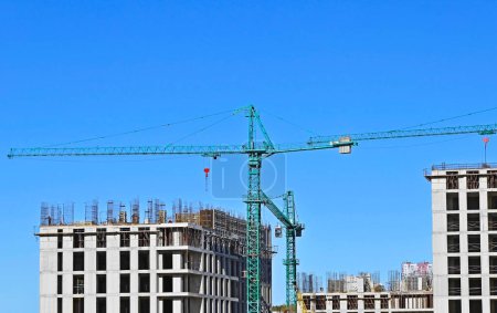 Photo for Crane and construction site against blue sky - Royalty Free Image