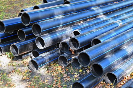 Photo for Stacked PVC pipes for drinking water on construction site - Royalty Free Image