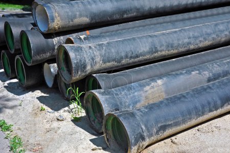 Photo for Reinforced concrete sewer pipes, stacked on construction site - Royalty Free Image