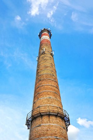 Photo for Old red chimney of boiler house from red brick - Royalty Free Image
