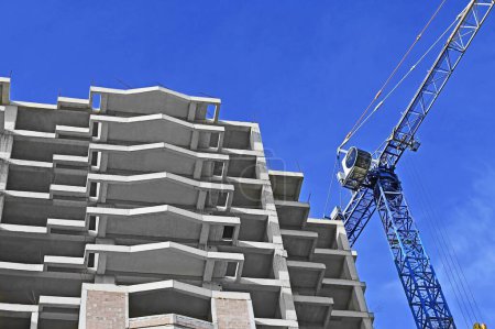 Photo for Highrise construction site and crane with blue sky - Royalty Free Image