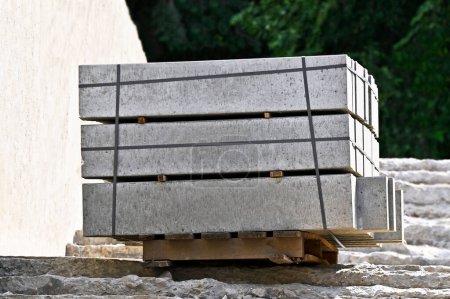 Stack of curbstones on pallets at construction site