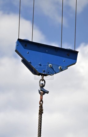 Crane winch with hook on blue sky background