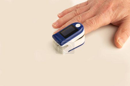 Foto de Hombre usando un medidor portátil de pulso cardíaco en un fondo blanco con espacio para copiar - Imagen libre de derechos