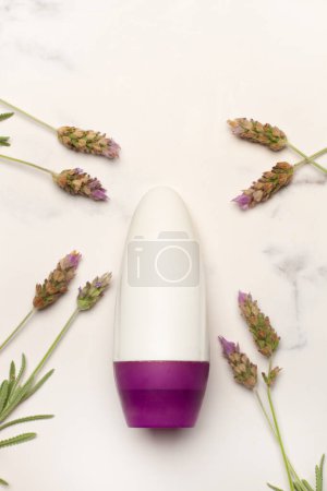 A blank plastic bottle with lavender flowers on a white and gray marble background
