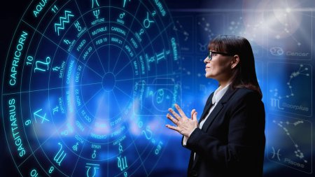 Photo for Woman interested in astrology, universe stars astrological wheel background. Horoscope, zodiac signs, predictions, future, astrology exoteric concept - Royalty Free Image