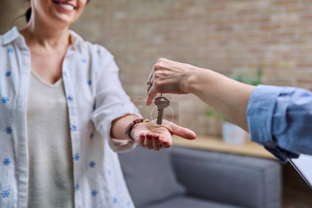 Photo for Mature woman buyer real estate tenant taking keys from realtor hands. Successful transaction, sale, rental property - Royalty Free Image