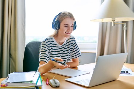 Photo for Teenage girl high school student in headphones having video conference on laptop computer at home remote lesson learning language online lecture educational webinar. E-education adolescence technology - Royalty Free Image