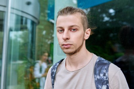 Photo for Headshot portrait of confident college student guy with backpack, looking at camera, outdoor, educational building background. Youth, education, lifestyle concept - Royalty Free Image