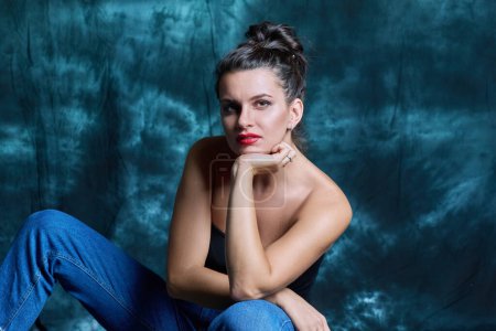 Photo for Beauty portrait of young sensual fashionable woman with hairstyle makeup, on dark studio background. Dreaming beautiful brunette looking at camera. Beauty, fashion, makeup, skin, hair - Royalty Free Image
