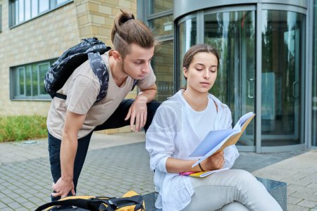 Photo for Two high school students guy and girl outdoor, school building background. Education, friendship, youth, adolescence concept - Royalty Free Image