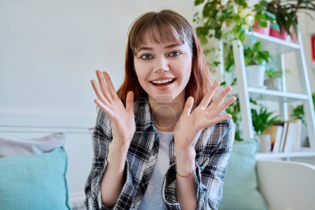 Photo for Web camera view of teenage girl 19-20 years old talking looking in camera, online meeting, video call chat conference. Teen trendy hipster female blogger vlogger recording video in home interior - Royalty Free Image