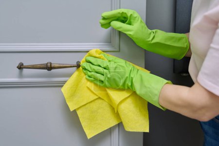 Photo for Close-up hands in protective gloves cleaning, wiping dust from furniture with soft cloth, polishing the wooden surfaces of furniture. Housekeeping, housework, housecleaning, cleaning service concept - Royalty Free Image