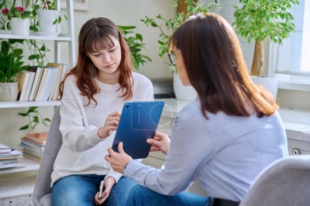 Photo for Teenage girl college student at therapy meeting with mental health professional social worker psychologist counselor sitting together in office. Psychology, psychotherapy, mental assistance support - Royalty Free Image