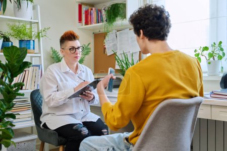 Photo for Female professional psychologist mental therapist working with young guy in office. Social worker counselor psychotherapist helping patient with difficulties stress depression. Psychology - Royalty Free Image