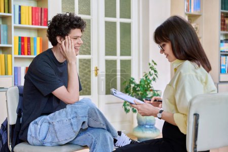 Female psychologist working with young male college student in office educational building. Mental health of youth, social service, psychology, psychotherapy, behavior, support treatment counselling