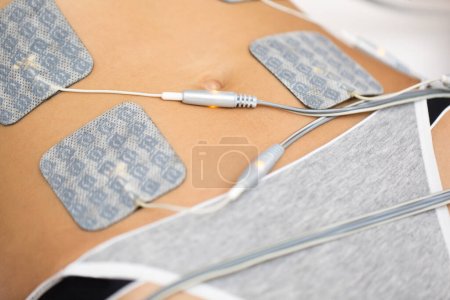 Photo for Therapist applying lipomassage on girls body in spa. Close-up of biostimulating apparatus for anti-cellulite lipomassage. Hardware cosmetology - Royalty Free Image