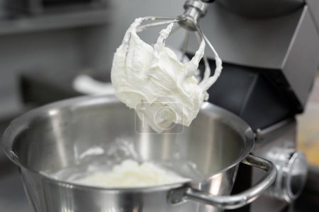 Photo for Cream or meringue on the Corolla of the kitchen machine, mixer. - Royalty Free Image